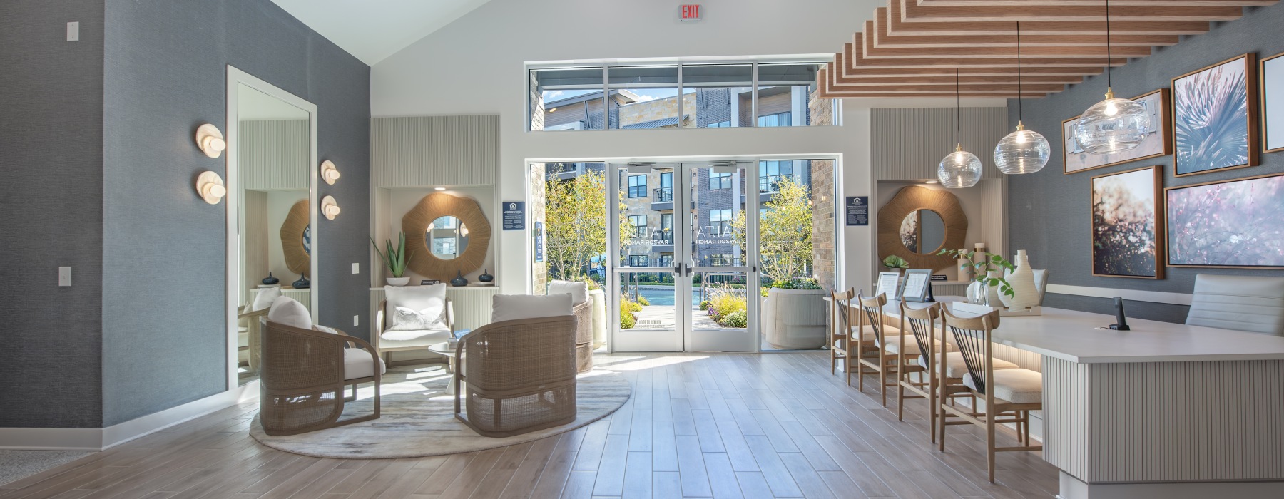long table, chairs and lounge area with view of front door
