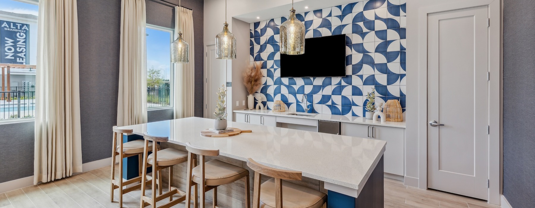 a clubhouse kitchen with a table and chairs