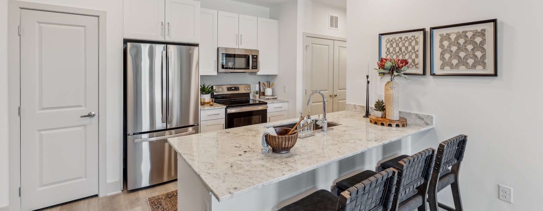 a kitchen with an island and chairs