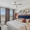 a bedroom with a bed, a nightstand and a dresser