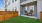 a backyard with chairs and a fence