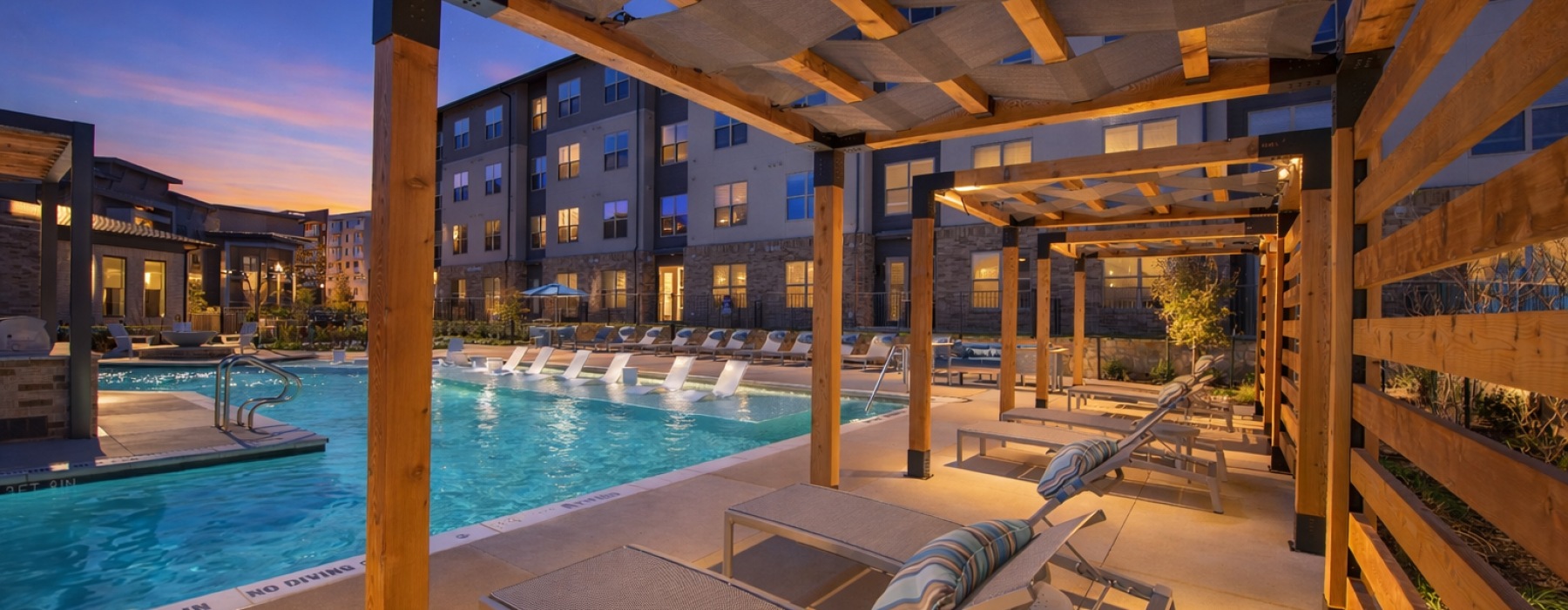 cabanas overlooking pool with sunset