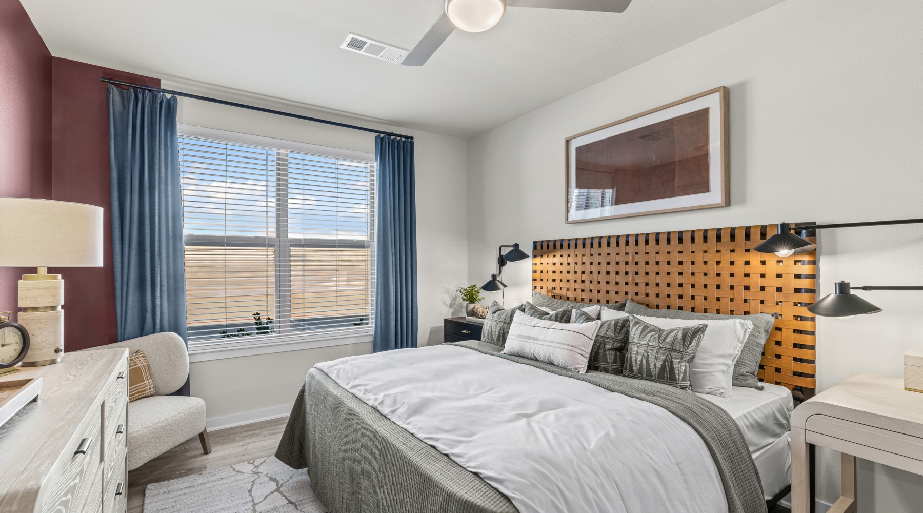 Spacious Bedrooms a bedroom with a bed, a nightstand and a dresser