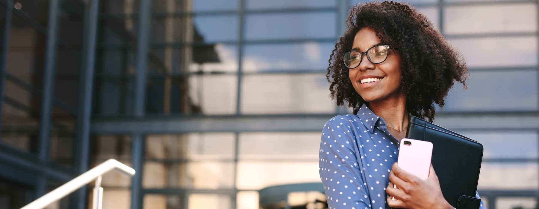 a business woman outside of a city area