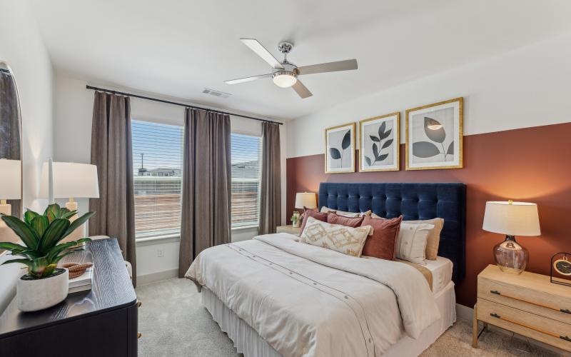 a bedroom with a bed and a fan