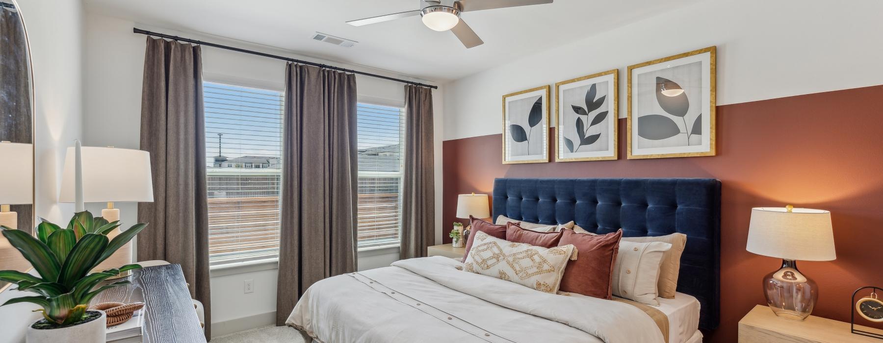 a bedroom with a bed and a fan