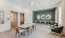 a clubhouse room with a table chairs and a green wall with mirrors